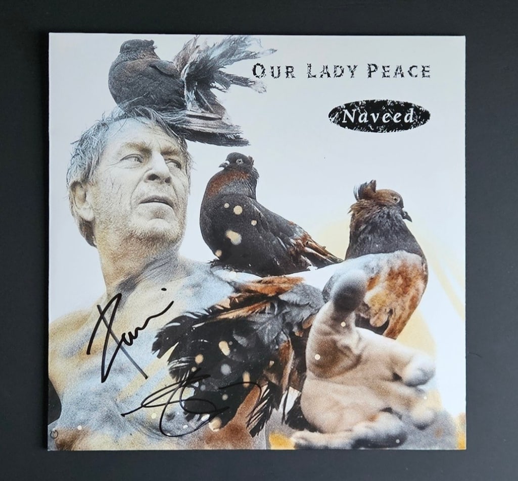 Our Lady Peace: Raine Maida & Jeremy Taggart Signed "Naveed" Album (2 Sigs) (Third Party Guaranteed): "Naveed" album signed on the cover in black felt tip marker by Our Lady Peace band members Raine Maida and Jeremy Taggart. Measuring approximately 12" x 12" and in fine condition. Record is included.