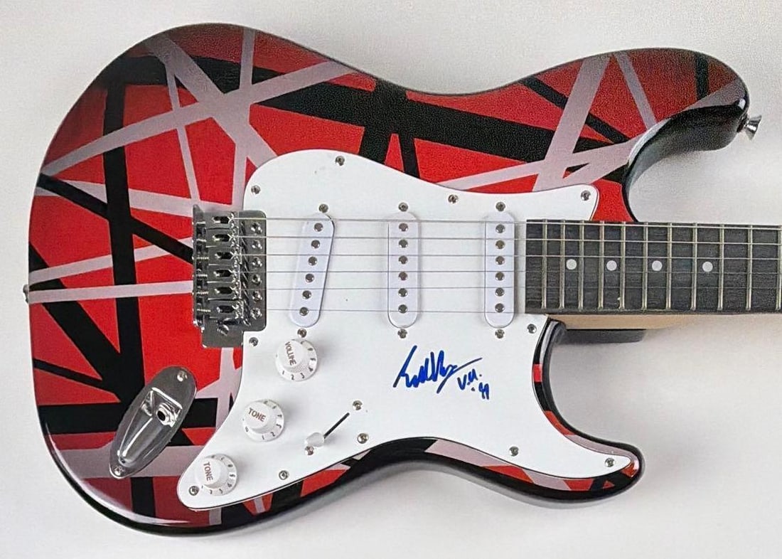 Van Halen: Eddie Van Halen Signed "Frankenstrat" Straocaster-Style Guitar: "Frankenstrat" designed Stratocaster-style guitar signed on the pickguard in bold blue felt tip marker by legendary Van Halen guitarist Eddie Van Halen, who added his band acronym "VH" and the year "9