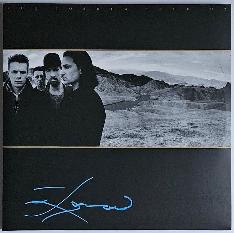 U2: Daniel Lanois Signed "Joshua Tree" Album Re-Issue (Third Party Guaranteed): "Joshua Tree" album signed on the cover in blue paint pen by producer Daniel Lanois. Measuring approximately 12" x 12" and in fine condition. Record is included. Provenance Eaton & Brennan Auctions