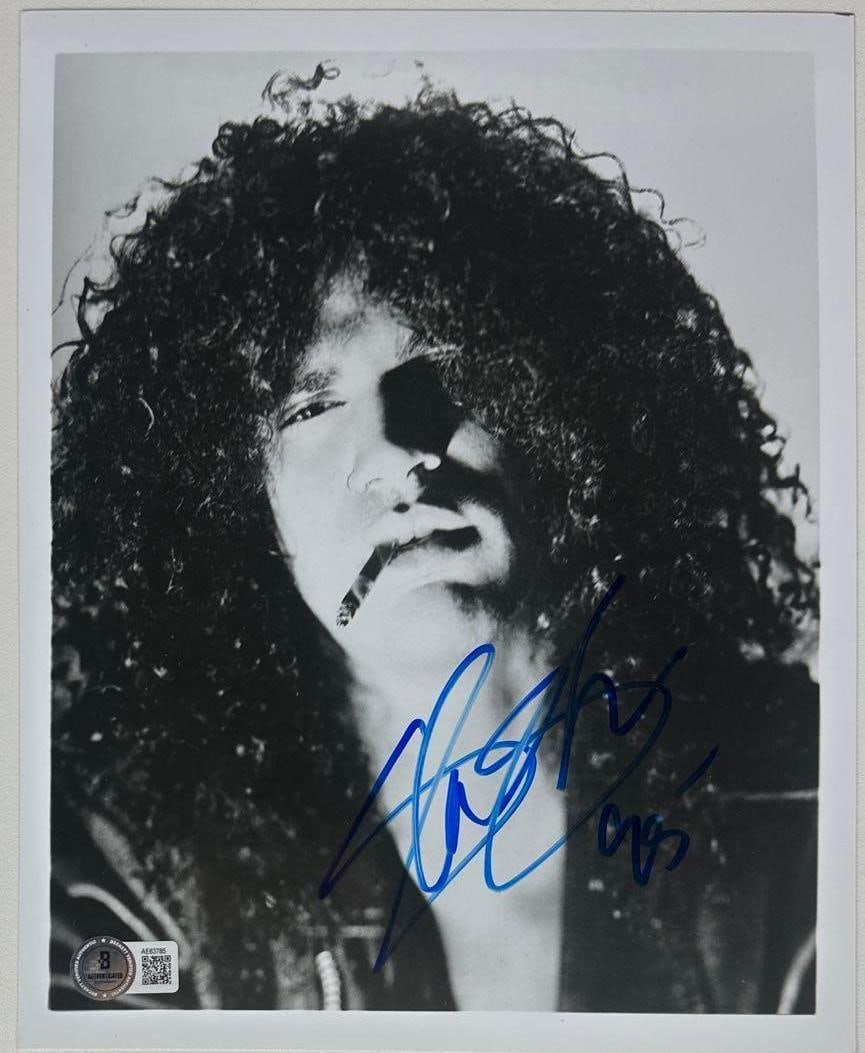 Guns N' Roses: Slash Signed 10" x 8" Photo (Beckett Authentication): Black-and-white 10" x 8" photo signed in blue felt tip marker by Guns N' Roses band member Slash, who inscribed the date "95" after his signature. In fine condition. Accompanied by a full Letter of