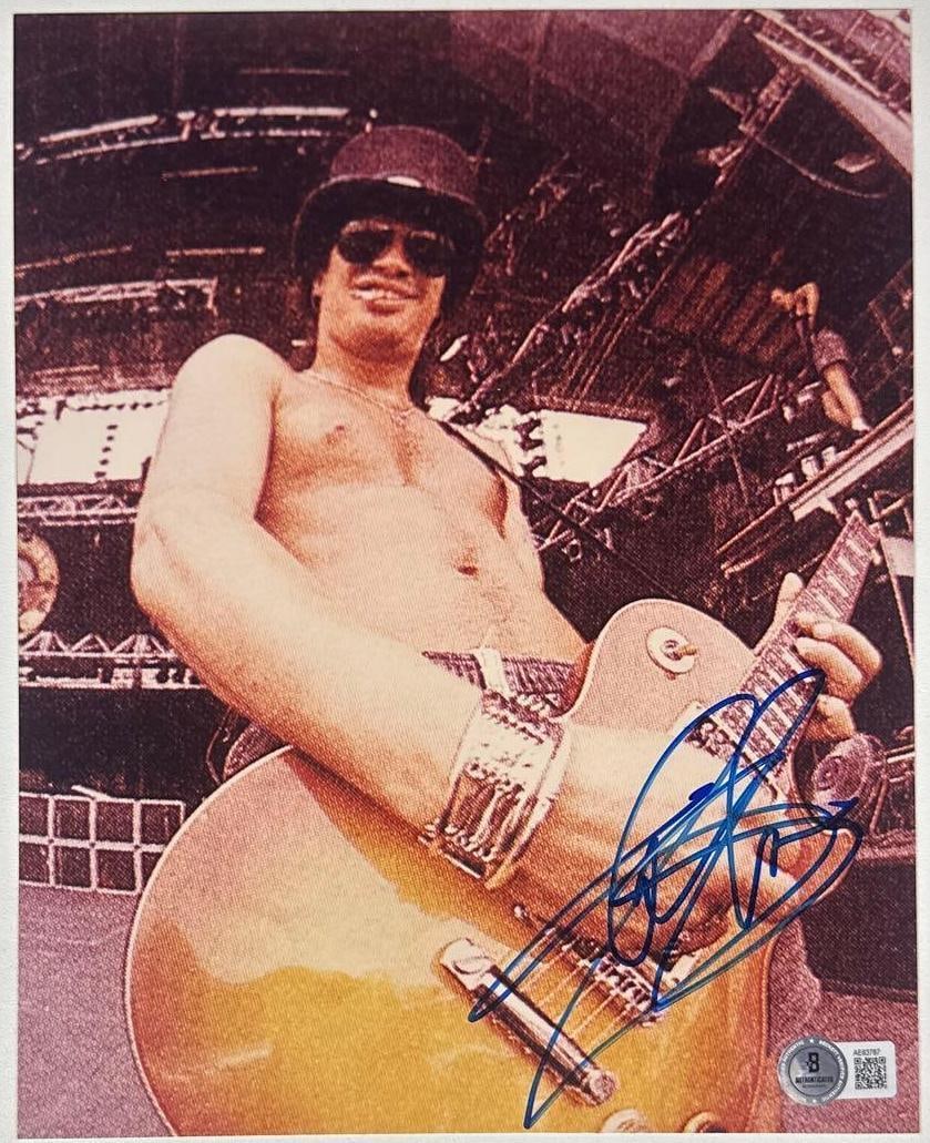 Guns N' Roses: Slash Signed 10" x 8" Photo (Beckett Authentication): Color 10" x 8" photo signed in blue felt tip marker by Guns N' Roses band member Slash. In fine condition. Accompanied by a full Letter of Authenticity from Beckett (#AE63787).