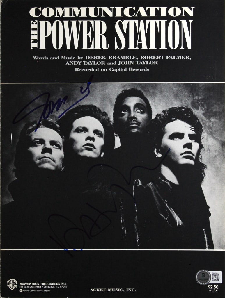 The Power Station Group Signed 12” x 9” "Communications" Sheet Music (2 Sigs) (Beckett): White 12” x 9” paper "Communications" sheet music signed on the cover in blue and black felt tip markers by the Power Station band members John Taylor and Robert Palmer. In fine