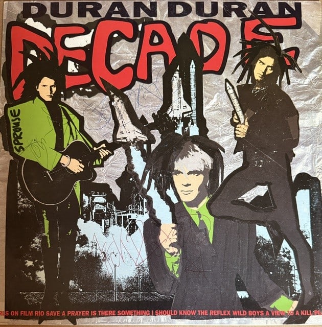 Duran Duran Group Signed "Decade" LP Album (3 Sigs) (Third Party Guaranteed): "Decade" LP album signed on the cover in black ballpoint pen by Duran Duran band members Nick Rhodes, John Taylor, and Simon Le Bon. Measuring approximately 12" x 12" and in fine condition. Record is