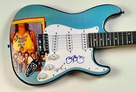 Jon Bon Jovi Signed Custom "Slippery When Wet" Graphics Electric Guitar (JSA & ACOA): "Slippery When Wet" custom graphics electric guitar signed on the pickguard in blue felt tip marker by Jon Bon Jovi. Measuring approximately 39" x 13" and in fine condition. Obtained in-person.