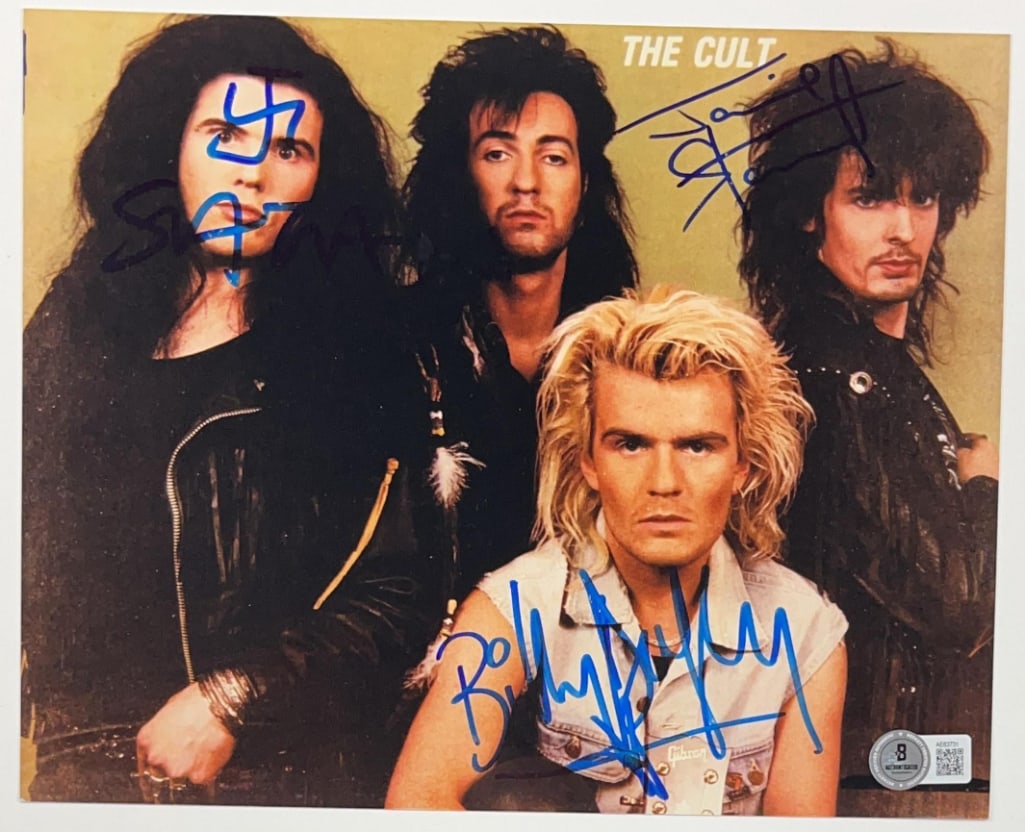 The Cult Group Signed 8” x 10” Promo Photo (3 Sigs) (Beckett Authentication): Color 8” x 10” promotional photo signed in blue felt tip marker by The Cult band members Ian Astbury, Billy Duffy, and Jamie Stewart. In fine condition. Obtained in-person. Accompanied by