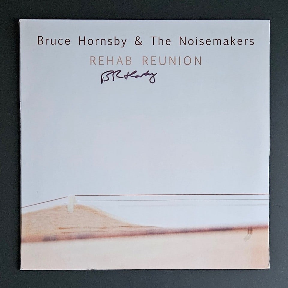 Bruce Hornsby & the Noisemakers Signed "Rehab Reunion" Album (Third Party Guaranteed): "Rehab Reunion" album signed on the cover in black felt tip marker by Bruce Hornsby & the Noisemakers front man Bruce Hornsby. Measuring approximately 12" x 12" and in fine condition. Record is