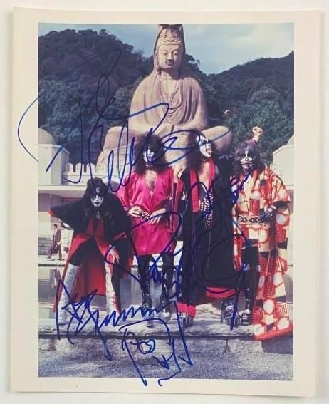 KISS Group Signed 10” x 8” Photo (4 Sigs) (Beckett Authentication): Color 10” x 8” photo signed in blue felt tip marker by KISS band members Gene Simmons, Ace Frehley, Paul Stanley, and Peter Criss. In fine condition. Obtained in-person. Accompanied by a