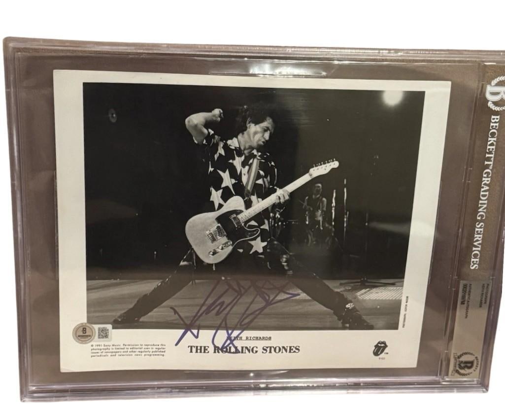 The Rolling Stones: Keith Richards Signed 8” x 10” Promo Photo (Beckett Encapsulated): Black-and-white 8” x 10” promotional photo signed in blue felt tip marker by the Rolling Stones band member Keith Richards. In fine condition. Encapsulated and authenticated by Beckett