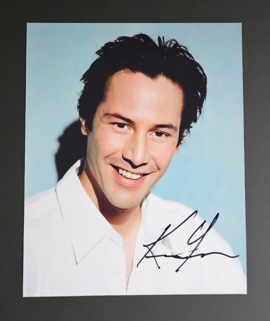 Keanu Reeves Signed 10" x 8" Photo (Third Party Guaranteed): Color 10" x 8" photo signed in black felt tip marker by actor Keanu Reeves. In fine condition. Provenance Eaton & Brennan Auctions guarantees this lot to pass Third-Party Authentication. Please