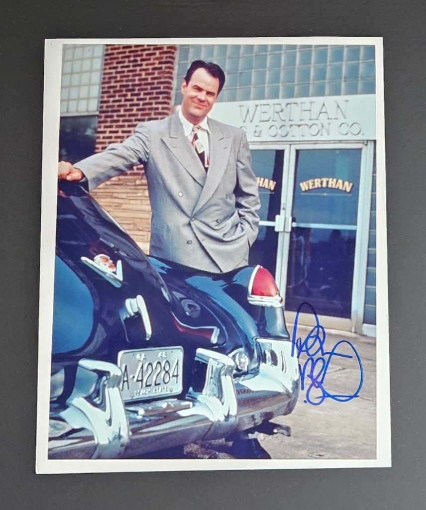 Driving Miss Daisy: Dan Akroyd Signed 10" x 8" Photo as Boolie Werthman (Third Party Guaranteed): Color 10" x 8" photo of the character Boolie Werthman from the film "Driving Miss Daisy" signed in blue felt tip marker by actor and comedian Dan Akyroyd. In fine condition. Provenance Eaton &