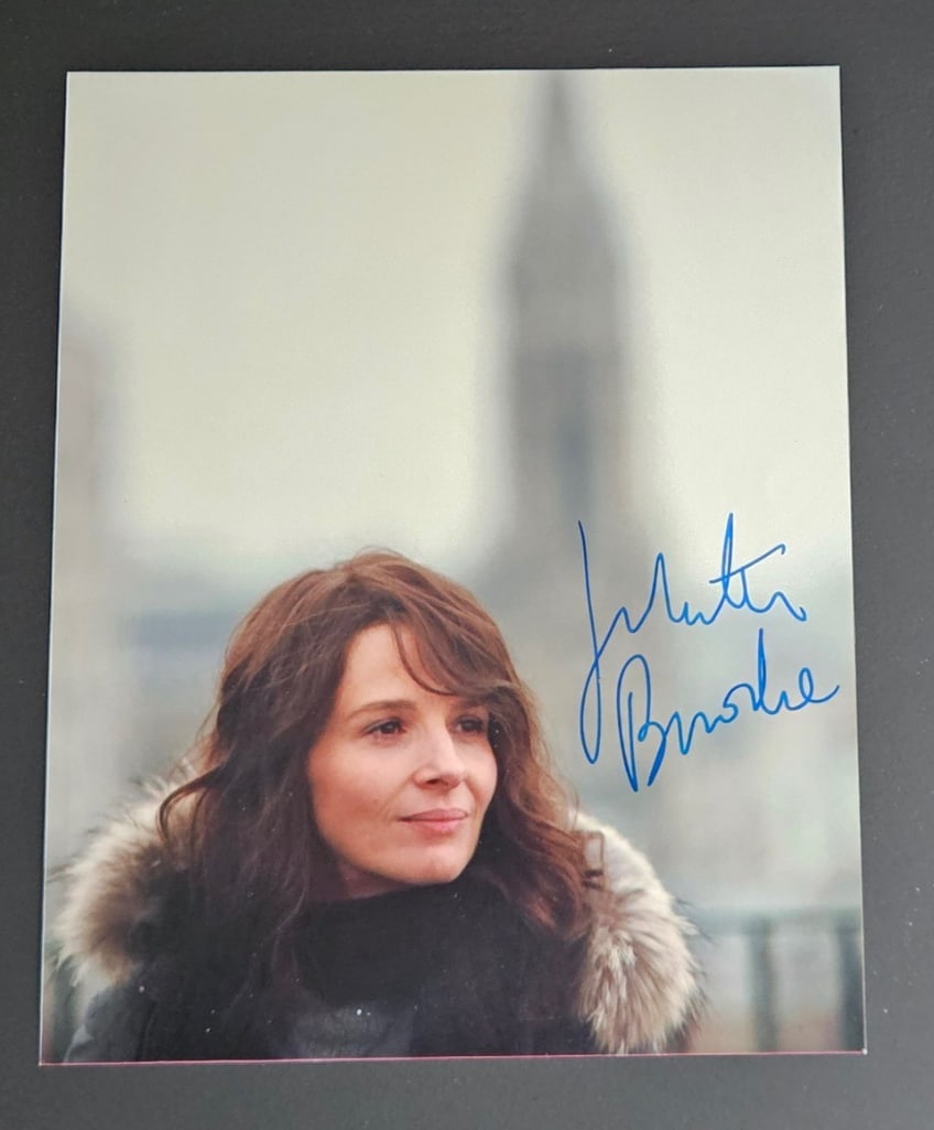Paris: Juliette Binoche Signed 10" x 8" Photo as Elise (Third Party Guaranteed): Color 10" x 8" photo of the character Elise from the film "Paris" signed in blue felt tip marker by actress Juliette Binoche. In fine condition. Provenance Eaton & Brennan Auctions guarantees this
