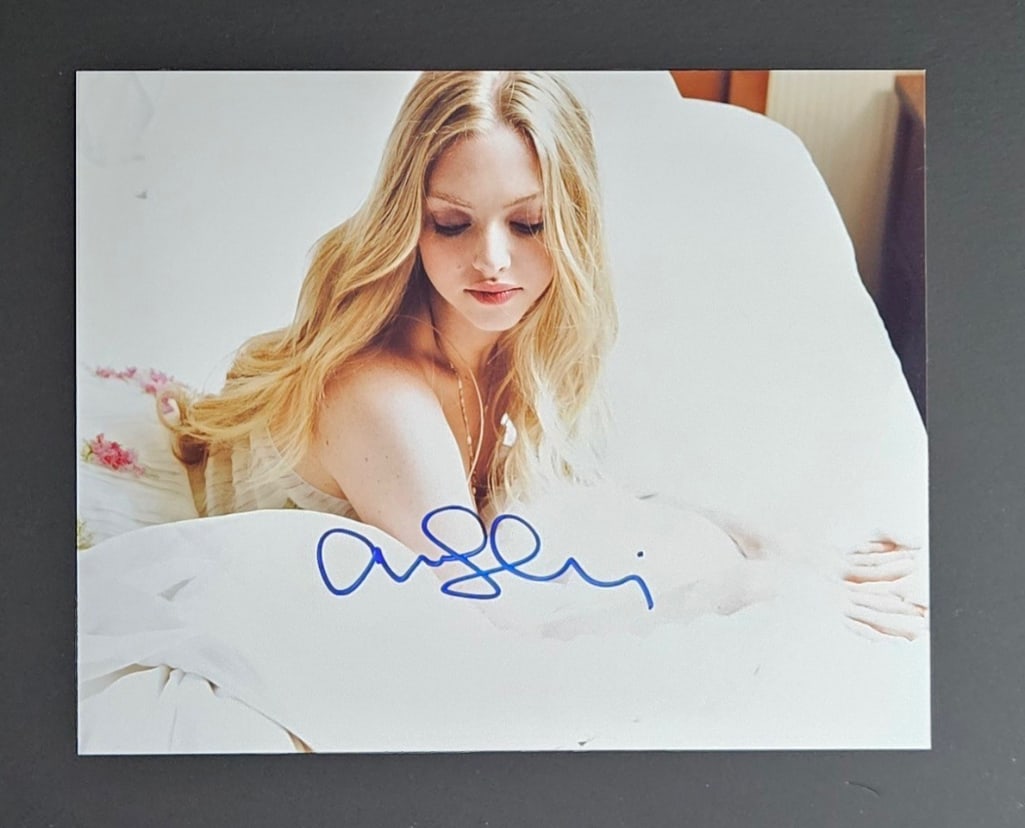 Amanda Seyfried Signed 8" x 10" Photo (Third Party Guaranteed): Color 8" x 10" photo signed in blue felt tip marker by actress Amanda Seyfried. In fine condition. Provenance Eaton & Brennan Auctions guarantees this lot to pass Third-Party Authentication. Please