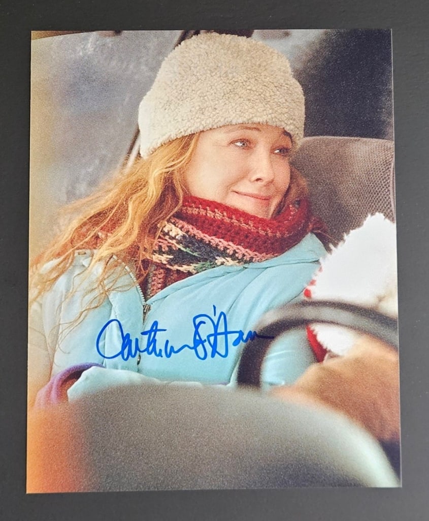 Saving Christmas: Catherine O'Hara Signed 10" x 8" Photo as Christine Valco (Third Party Guaranteed): Color 10" x 8" photo of the character Christine Valco from the film "Surviving Christmas" signed in blue felt tip marker by actress Catherine O'Hara. In fine condition. Provenance Eaton & Brennan
