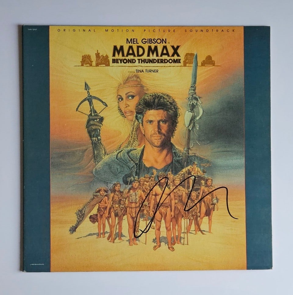 Mad Max Beyond Thunderdome: George Miller Signed Soundtrack Album (Third Party Guaranteed): "Mad Max Beyond Thunderdome" soundtrack album signed on the cover in black felt tip marker by director George Miller. Measuring approximately 12" x 12" and in fine condition. Record is included.