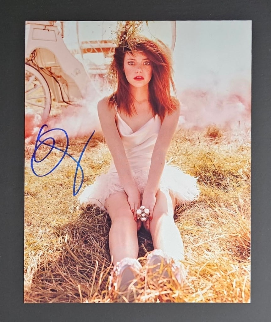 Emma Stone Signed 10" x 8" Photo (Third Party Guaranteed): Color 10" x 8" photo signed in blue felt tip marker by actress Emma Stone. In fine condition. Provenance Eaton & Brennan Auctions guarantees this lot to pass Third-Party Authentication. Please review