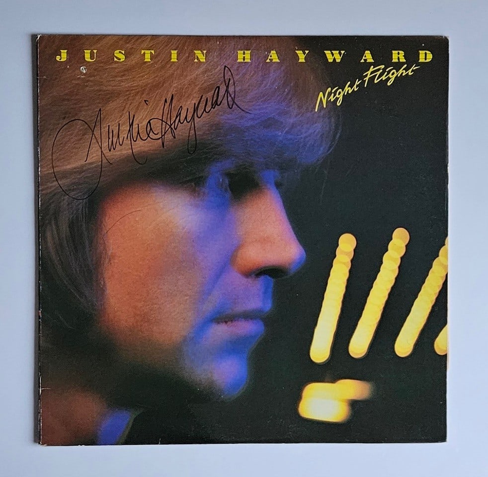 Moody Blues: Justin Hayward Signed "Night Flight" Album (Third Party Guaranteed): "Night Flight" album signed on the cover in black felt tip marker by Moody Blues band member Justin Hayward. Measuring approximately 12" x 12" and in very good condition, with some signs of scattered 