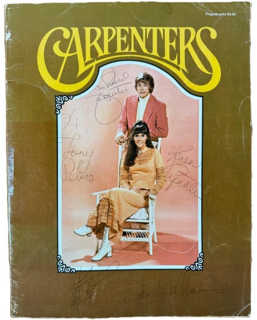 The Carpenters Group Signed 1972 Concert Program (5 Sigs) (PSA/DNA Authentication): Color 13" x 10" concert program signed on the cover in blue ballpoint pen by The Carpenters duo members Karen and Richard Carpenter, as well as session performers and Danny Woodhams and Tony Peluso, w