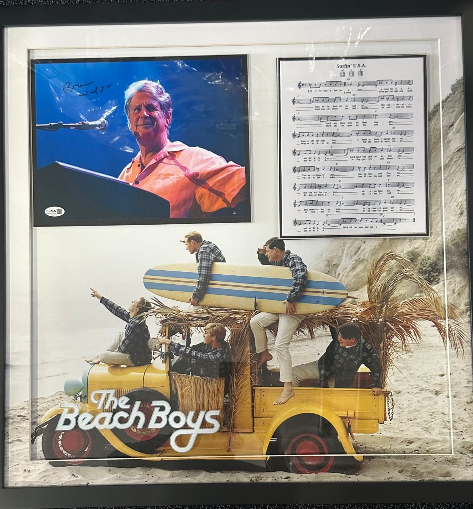 The Beach Boys: Brian Wilson Signed 8" x 10" Photo Framed Display W/ Lyric Sheet (JSA): Color 8" x 10" photo framed display with lyric sheet signed in black felt tip marker by the Beach Boys band member Brian Wilson. Photo is displayed in a frame with the lyric sheet in measuring 26" x