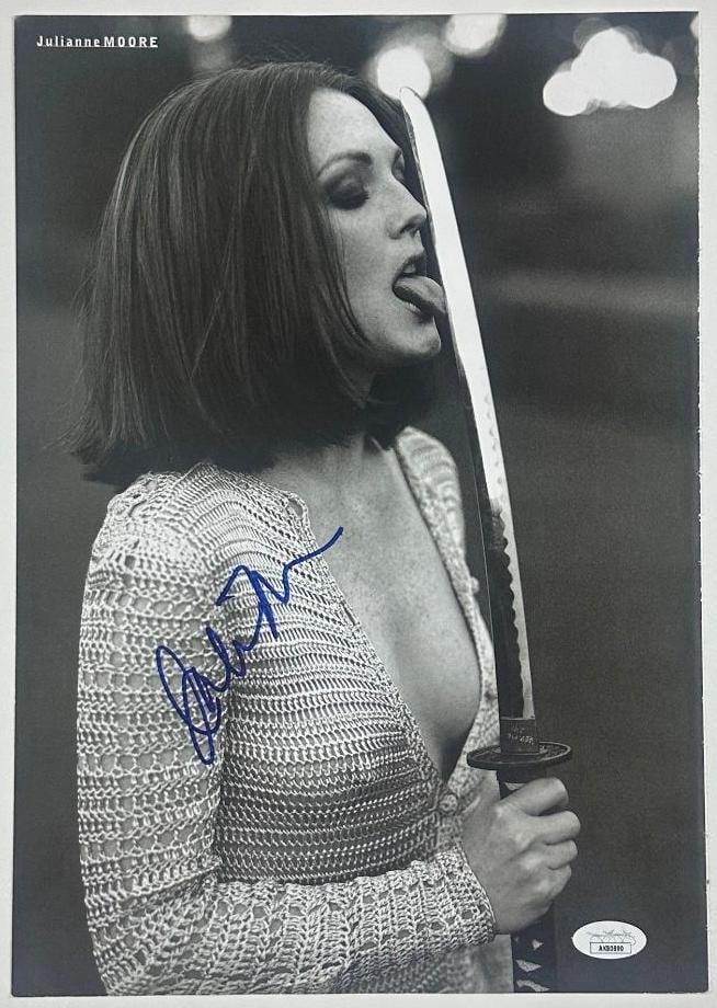 Julianne Moore Signed Photo (JSA Authentication): Black and white photo of actress Julianne Moore, signed in blue felt tip marker across the shoulder. Accompanied by a JSA sticker affixed to the bottom right corner (#AK80890). Measuring