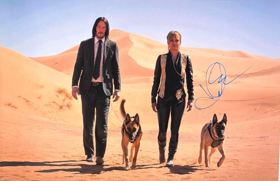 John Wick Chapter 3 Parabellum: Halle Berry Signed 11" x 17" Photo (SWAU): Color 17" x 11" photo of the character Sofia Al-Azwar from the film "John Wick Chapter 3: Parabellum" signed in blue paint pen by actress Halle Berry. In fine condition. Accompanied by an auction lett