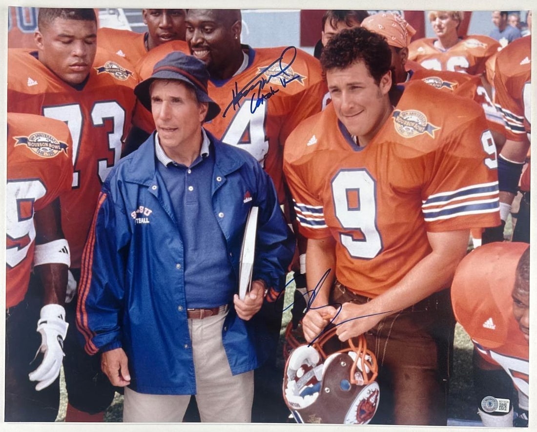 The Waterboy: Adam Sandler & Henry Winkler Signed 15.75" x 20" Photo (2 Sigs) (Beckett): Color 15.75" x 20" photo of the characters Bobby Boucher Jr. and Coach Klein from the film "The Waterboy" signed in blue felt tip marker by actors Adam Sandler and Henry Winkler, who inscribed his cha