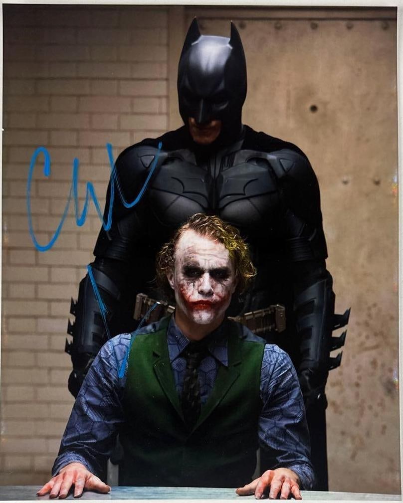 The Dark Knight: Christian Bale Signed 10" x 8" Photo as Batman (Third Party Guaranteed): Color 10" x 8" photo of the character Batman from the film "The Dark Knight" signed in blue paint pen by actor Christian Bale. In fine condition. Provenance Eaton & Brennan Auctions guarantees this