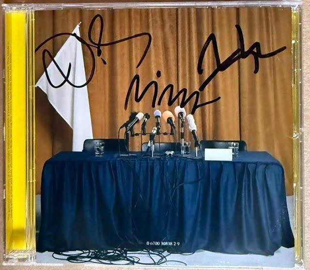 A Camp Fully Group Signed "Colonia" CD (3 Sigs) (Third Party Guaranteed): "Colonia" CD signed on the inner sleeve in black felt tip marker by A Camp band members Nina Persson, Niclas Frisk, and Nathan Larson. Measuring approximately 5" x 5" and in fine condition. CD is incl