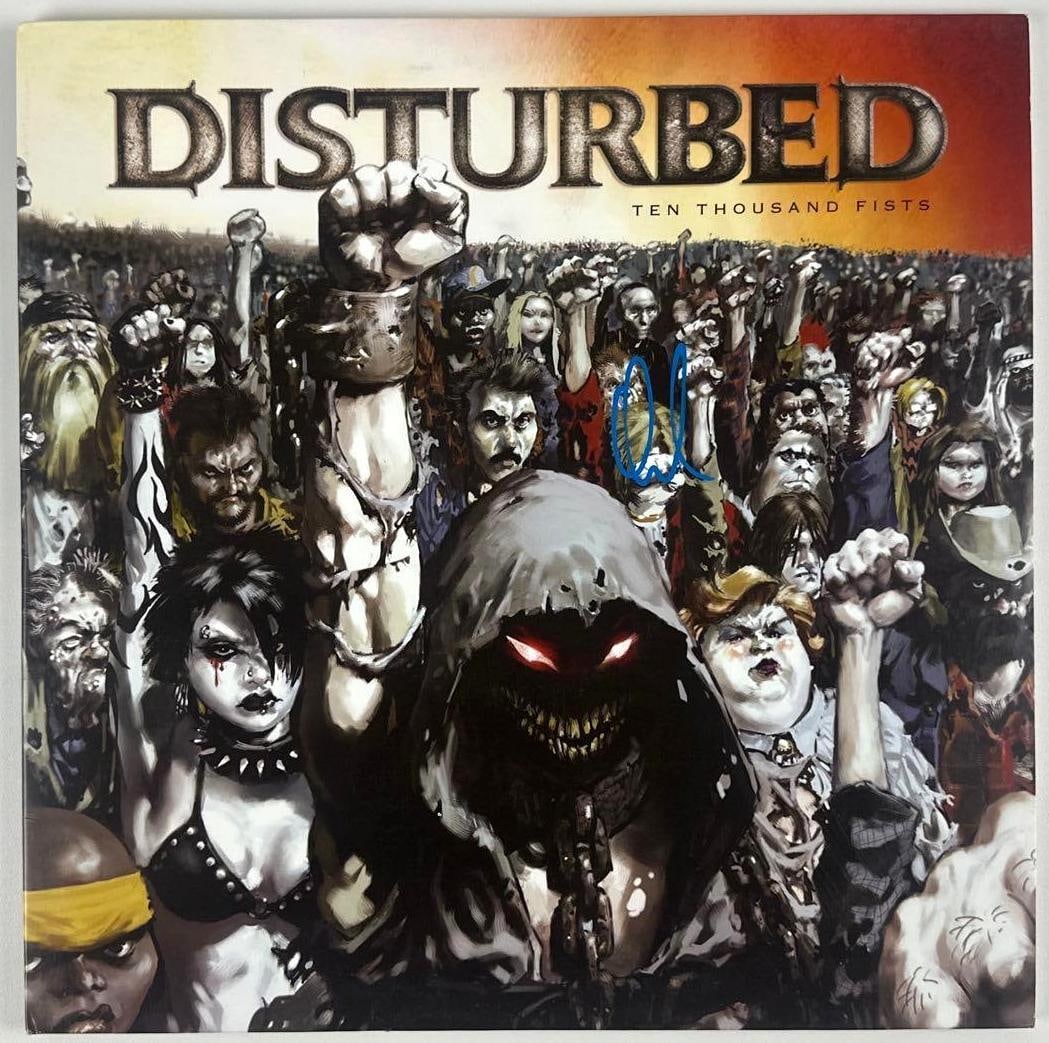 Disturbed: X Signed "Ten Thousand Fists" Album (PSA/DNA Authentication): "Ten Thousand Fists" album signed on the cover in blue paint pen by Disturbed band member X. Measuring approximately 12" x 12" and in fine condition. Authenticated by PSA/DNA, with their official holo