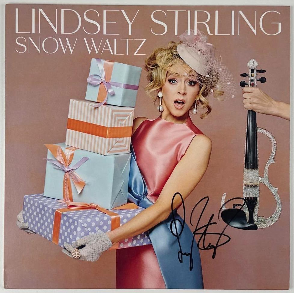 Lindsey Stirling Signed "Snow Waltz" Album (Beckett Authentication): "Snow Waltz" album signed on the cover in black felt tip marker by musician Lindsey Stirling. Measuring approximately 12" x 12" and in fine condition. Record is included. With a Beckett sticker