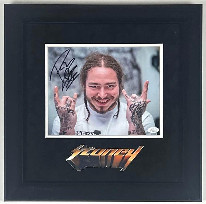 Post Malone Signed 8" x 10" "Stoney" Photo Framed Display (JSA Authentication): Color 8" x 10" "Stoney" photo signed in black felt tip marker by musician Post Malone. Signed photo measures approximately 8" x 10" and is displayed in a frame measuring 17" x 17" overall. In fine