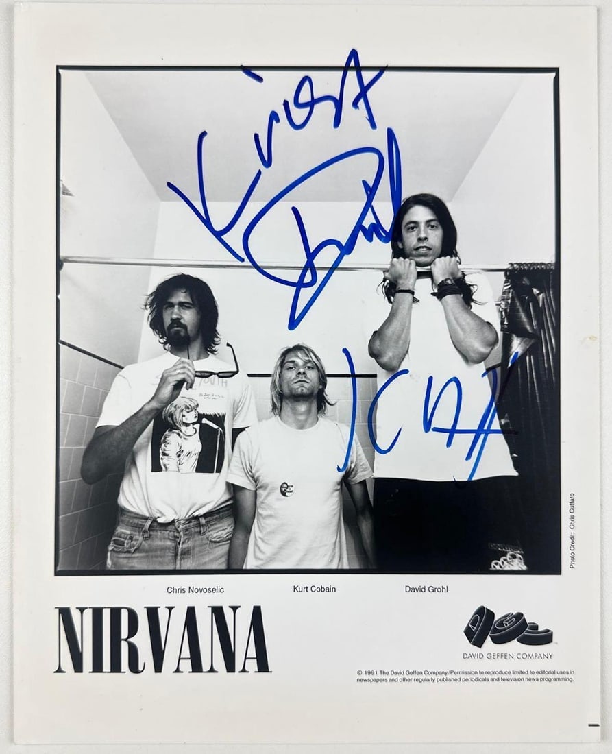 Nirvana Fully Group Signed 10" x 8" 1991 Promo Photo (3 Sigs) (Beckett): Rare black-and-white 10" x 8" 1991 promotional photograph signed in blue felt tip marker by all three members of Nirvana: Kurt Cobain, Dave Grohl, and Krist Novoselic. In fine condition. Accompanied b