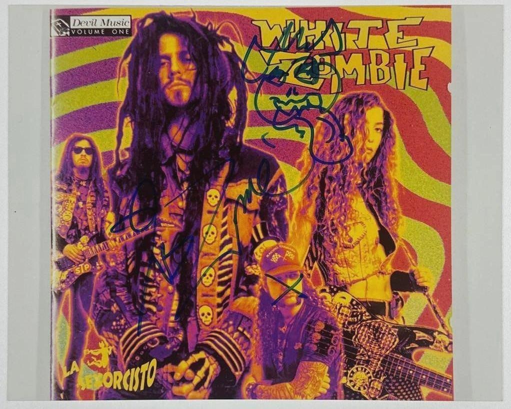 White Zombie Group Signed 8" x 10" Photo (4 Sigs) (JSA Authentication): Color 8" x 10" photo signed in blue felt tip marker by White Zombie band members Rob Zombie, Sean Yseult, Jay Noel Yuenger, and Ivan de Prume. In fine condition. Authenticated by JSA. A desirable full