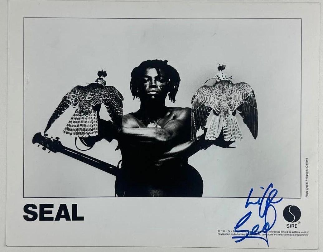 Seal Signed 8" x 10" Promo Photo (JSA Authentication): Black-and-white 8" x 10" promotional photo signed in blue felt tip marker by musician Seal, who inscribed "love" before his signature. In fine condition. Authenticated by JSA. Provenance This piece