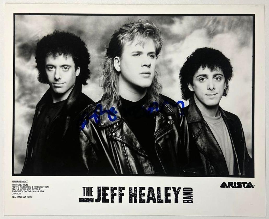 Jeff Healey Signed 8" x 10" "The Jeff Healey Band" Promo Photo (JSA): Black-and-white 8" x 10" promotional "The Jeff Healey Band" photo signed in blue felt tip marker by front man Jeff Healey. In fine condition. Authenticated by JSA. Provenance This piece was recently