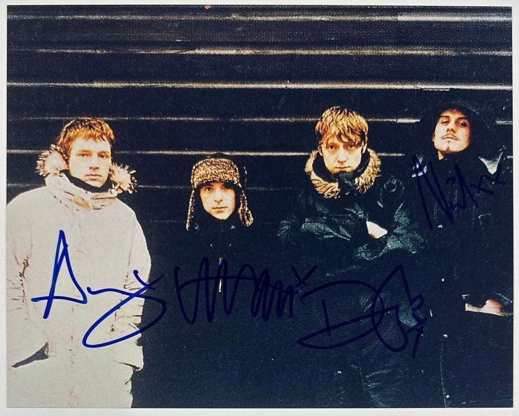 Travis Fully Group Signed 8" x 10" Photo (4 Sigs) (Third Party Guaranteed): Color 8" x 10" photo signed in blue felt tip marker by Travis band members Fran Healy, Andy Dunlop, Dougie Payne, and Neil Primrose. In fine condition. Provenance Eaton & Brennan Auctions guarantees t