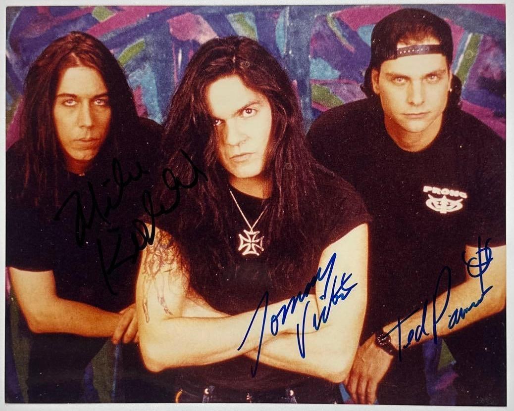 Prong Group Signed 8" x 10" Photo (3 Sigs) (Third Party Guaranteed): Color 8" x 10" photo signed in blue and black felt tip markers by Prong band members Tommy Victor, Mike Kirkland, and Ted Parsons. In fine condition. Provenance Eaton & Brennan Auctions guarantees