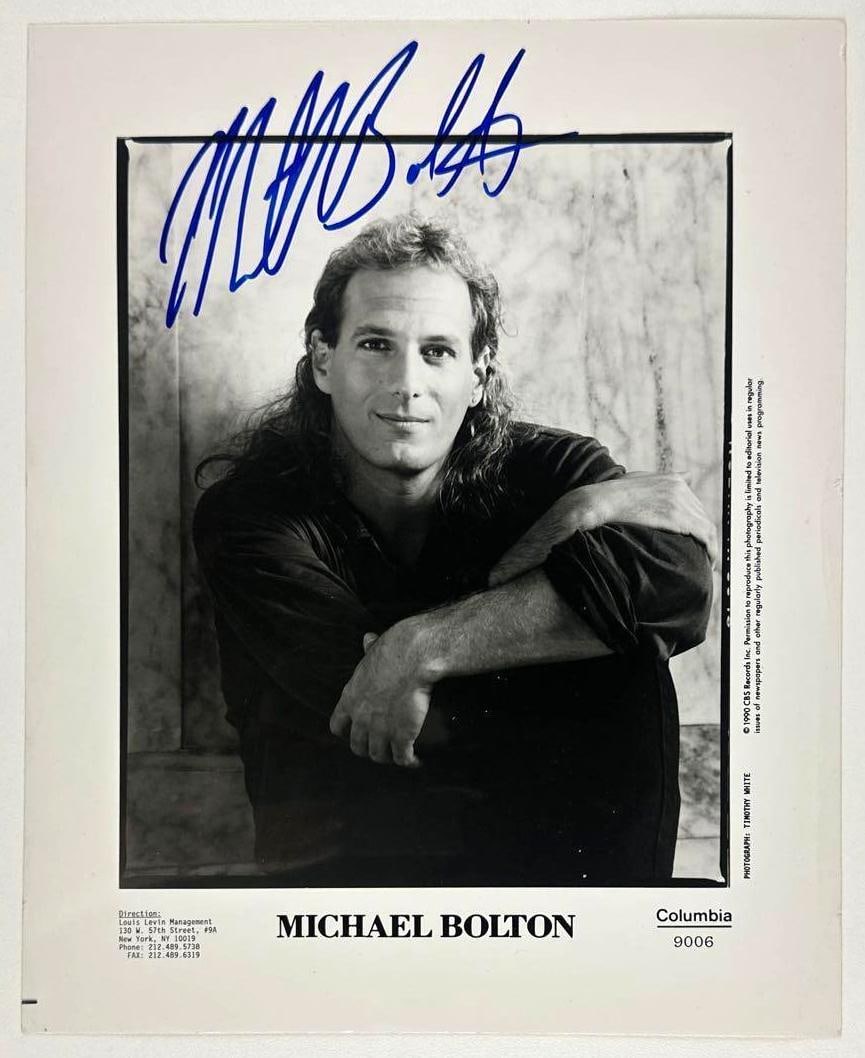 Michael Bolton Signed 8" x 10" Promo Photo (Third Party Guaranteed): Black-and-white 8" x 10" promotional photo signed in blue felt tip marker by musician Michael Bolton. In fine condition. Provenance Eaton & Brennan Auctions guarantees this lot to pass Third-Party