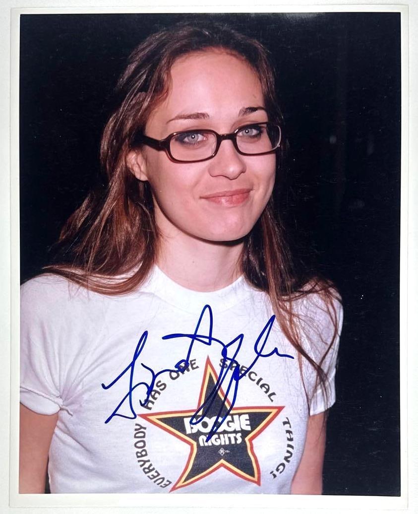 Fiona Apple Signed 8" x 10" Photo (Third Party Guaranteed): Color 8" x 10" photo signed in blue felt tip marker by musician Fiona Apple. In fine condition. Provenance Eaton & Brennan Auctions guarantees this lot to pass Third-Party Authentication. Please