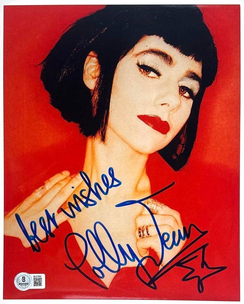 Polly Jean PJ Harvey Signed 10 x 8" Photo (Beckett Authentication): Color 10" x 8" photo signed in blue felt tip marker by musician PJ Harvey "Polly Jean," who also inscribed "best wishes" before her signature. In fine condition. Authenticated by Beckett, with their