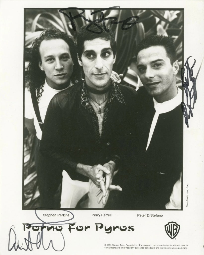 Porno For Pyros Group Signed 8" x 10" Promo Photo (3 Sigs) ACOA): Black-and-white 10" x 8" promotional photo signed in black felt tip marker by Porno For Pyros band members Perry Farrell, Stephen Perkins, and Peter DiStefano. In fine condition. Accompanied by an ACO