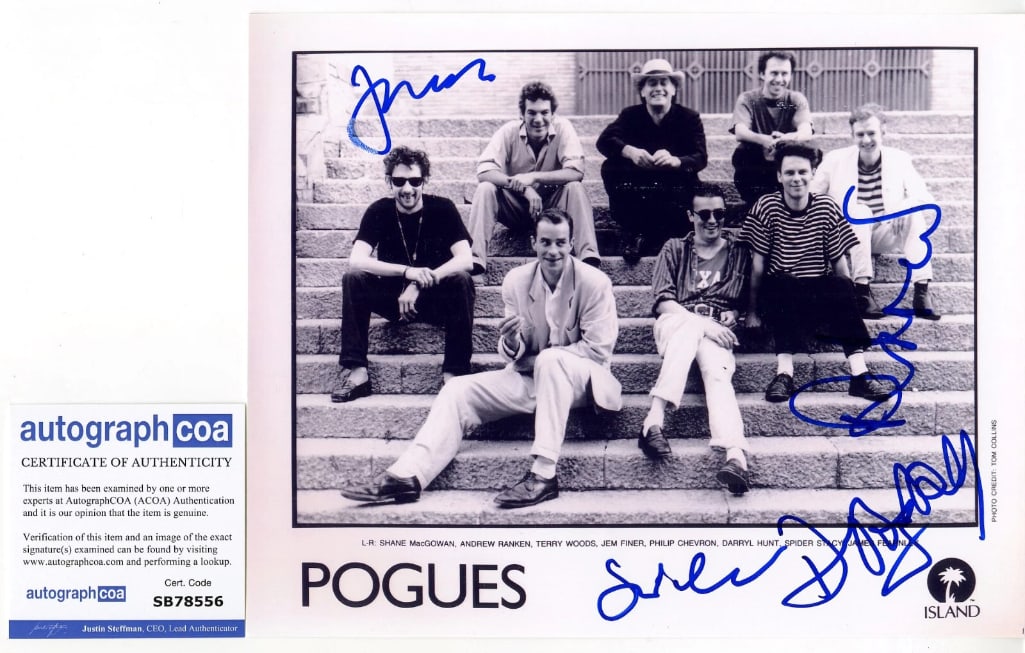 The Pogues Group Signed 8" x 10" Proo Photo (4 Sigs) (ACOA Authentication): Black-and-white 8" x 10" promotional photo signed in blue felt tip marker by The Pogues band members Spider Stacy, James Fearnley, Andrew Ranken, and Darryl Hunt. In fine condition. Accompanied by an