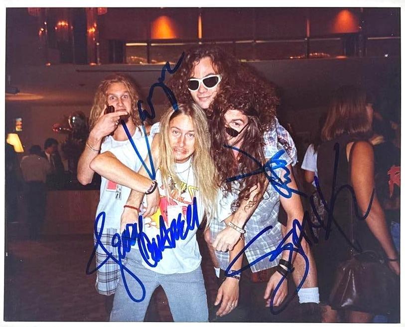 Alice in Chains Fully Group Signed Candid 8" x 10" Photo (4 Sigs) (Beckett Authentication): Utra-rare 8" x 10" color photo of Alice In Chains, boldly signed in blue felt tip marker by all four original members: Layne Staley, Jerry Cantrell, Mike Starr, and Sean Kinney. This candid, playful