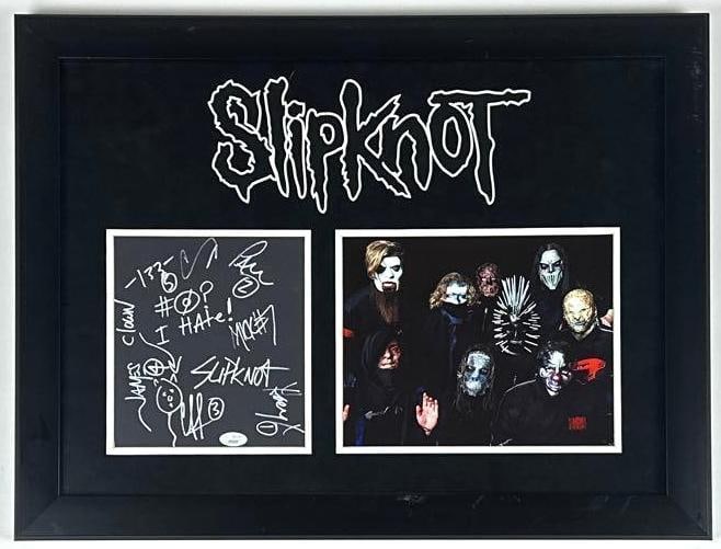 Slipknot Group Signed 8" x 7" Cut Framed Display (7 Sigs) (JSA Authentication): Black paper 8" x 7" cut frame display signed in silver felt tip markers by Slipknot band members Corey Taylor, Joey Jordison, Mick Thomson, Shawn Craham, Chris Fehn, Paul Gray, and Jim Root. Signed