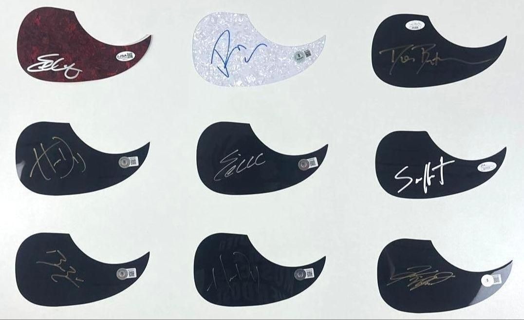 Group Lot of (9) Signed Acoustic Pickguards (Beckett & JSA Authentication): Group lot of (9) signed acoustic-style pickguards. First red-black color pickguard signed in silver felt tip marker by musician Eric Church. In fine condition. Accompanied by a JSA COA (#CK85307).
