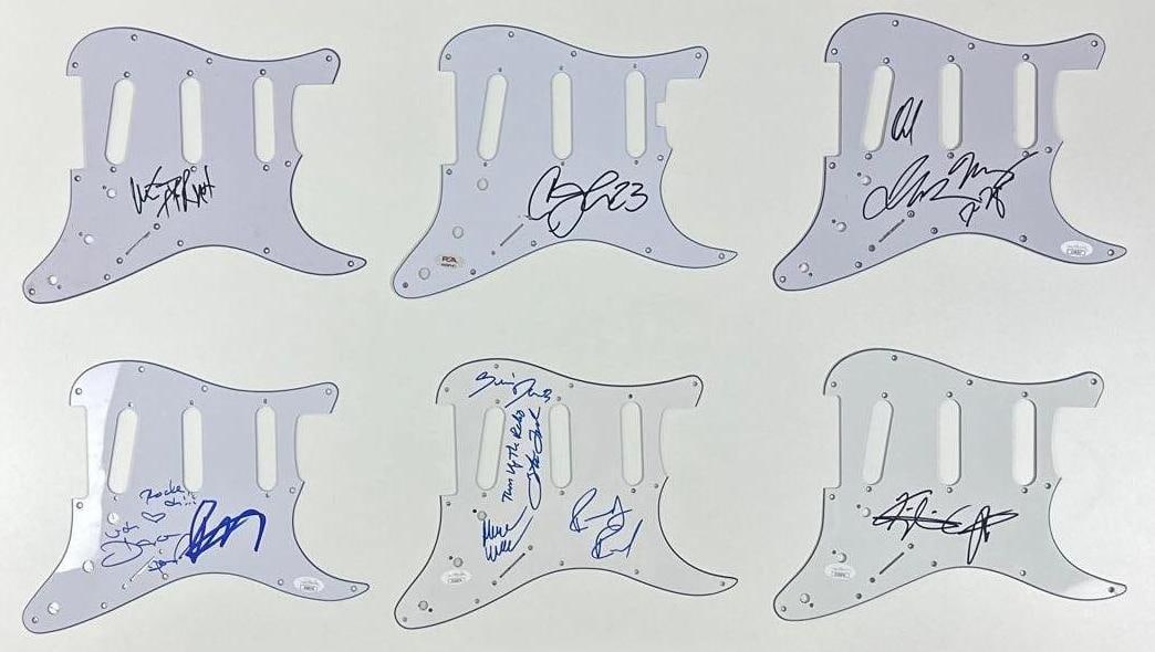 Group Lot of (6) Signed Stratocaster-Style Pickguards (JSA & PSA/DNA): Group of (6) signed white 9" x 11" Stratocaster-style pickguards. First pickguard signed in black felt tip marker by Green Day band member Mike Dirnt. In fine condition. Second pickguard signed in