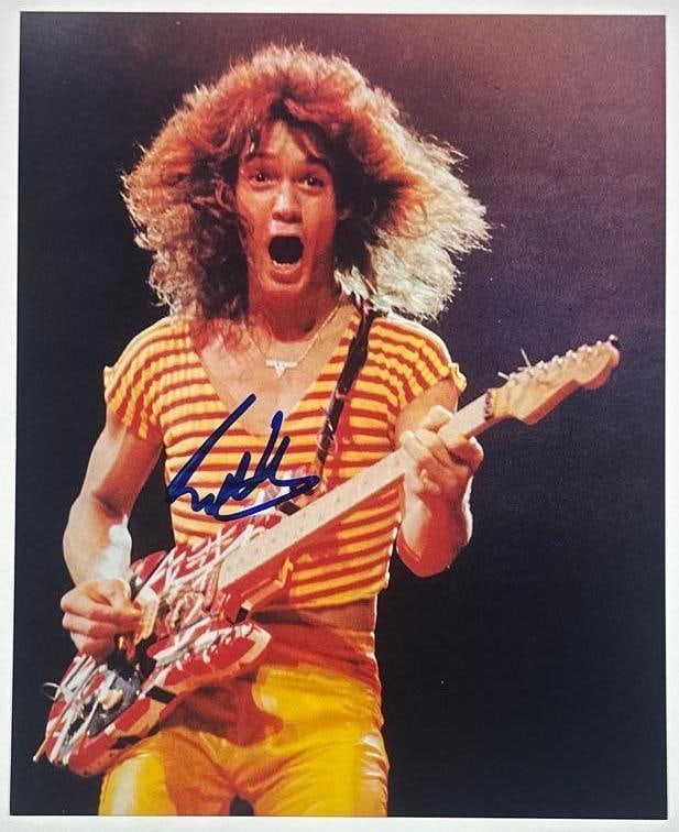 Van Halen: Eddie Van Halen Signed 8" x 10" Photo (Beckett Authentication): Color 8" x 10" photo signed in blue felt tip marker by Van Halen band member Eddie Van Halen. In fine condition. Accompanied by a full Letter of Authenticity from Beckett (#AD62697). A sought-after
