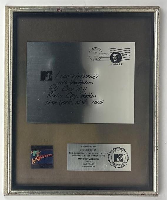 Van Halen "Lost Weekend" MTV Contest Award Presented to Chip Rachlin: MTV Promotional Contest Award presented to Chip Rachlin to commemorate the receipt of more than 1,000,000 contest entries in the MTV "Lost Weekend with Van Halen" promotion. The framed display, measur