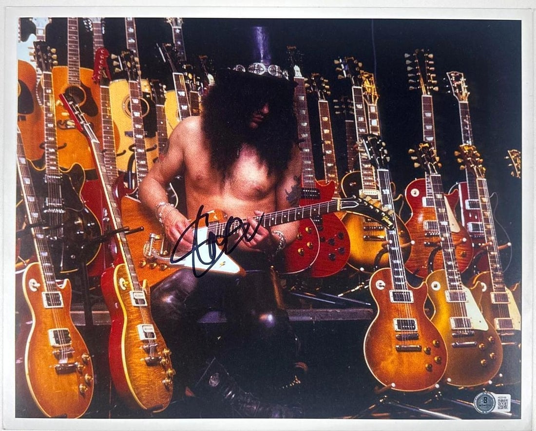 Guns N' Roses: Slash Signed 12" x 15" Photo (Beckett Authentication): Color 12" x 15" photo signed in black felt tip marker by Guns N' Roses band member Slash. In fine condition. Accompanied by a full Letter of Authenticity from Beckett (#AE23100).