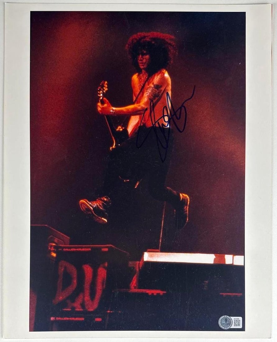Guns N' Roses: Slash Signed 14.25" x 9.5" Photo (Beckett Authentication): Color 14.25" x 9.5" photo signed in black felt tip marker by Guns N' Roses band member Slash. In fine condition. Accompanied by a full Letter of Authenticity from Beckett (#AE23095).