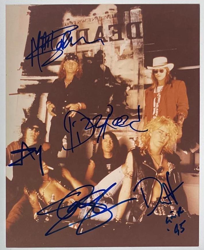 Guns N’ Roses Group Signed 8" x 10" Photo (5 Sigs) (Beckett Authentication): Color 8" x 10" photo signed in blue felt tip marker by Guns N' Roses band members Slash, Izzy Stradlin, Matt Sorum, Duff McKagan, who inscribed the band name "GNR" and the date "95" after his